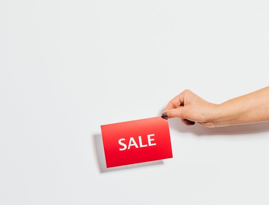 person holding sale card