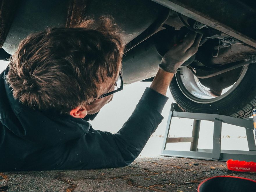 man fixing vehicle engine