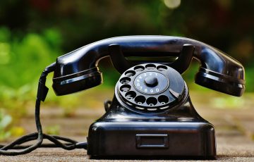 selective focus photography of black rotary phone