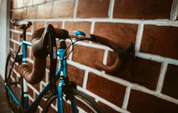 selective focus photography of blue road bike